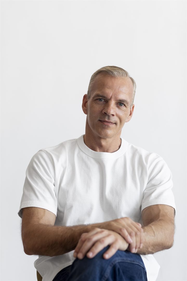 Original photo: a man in a white T-shirt against a plain white wall